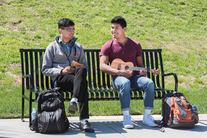 Two UTC students sitting on a bench
