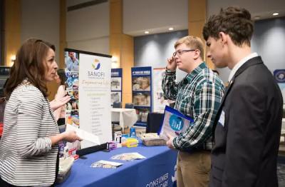 Students speaking with an employer at a career fair