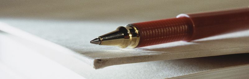 utc editorial guidelines pen sitting on pad of paper