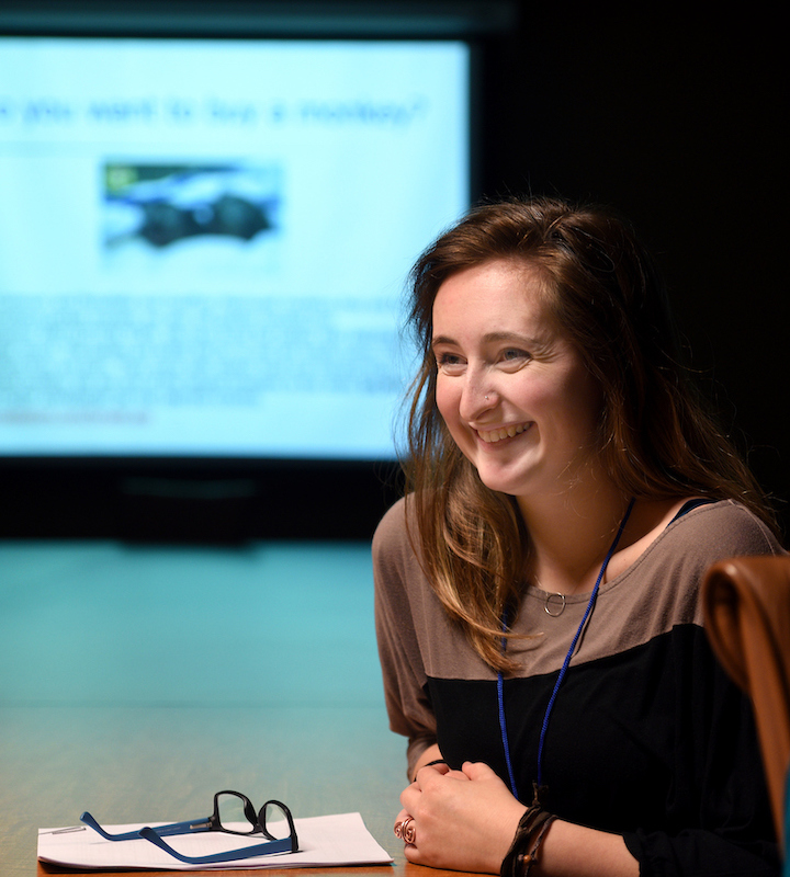 itac girl smiling in front of presentation