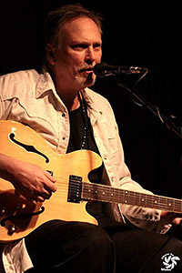 Musician and guitar Musician sings while playing guitar