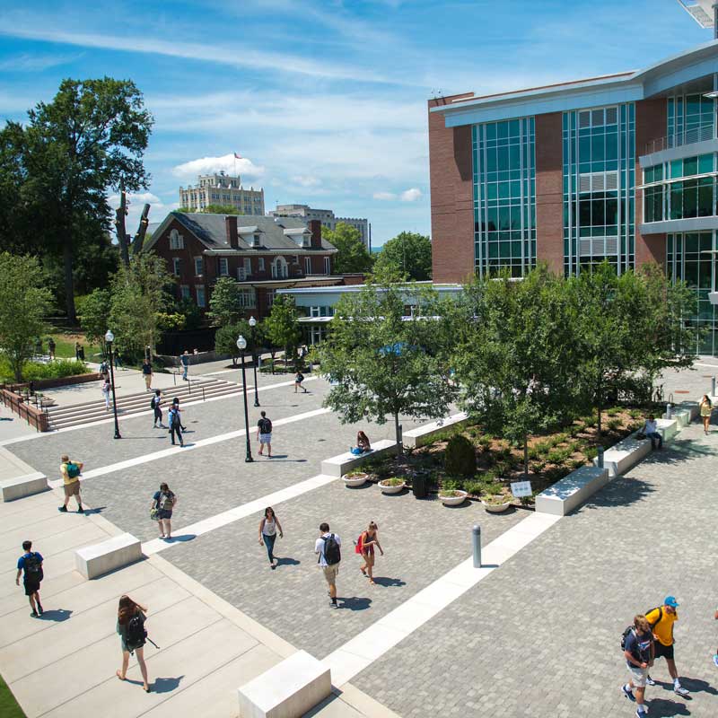 homepage-policies-procedures.jpeg overview photo taken outside of library shows students walking on campus