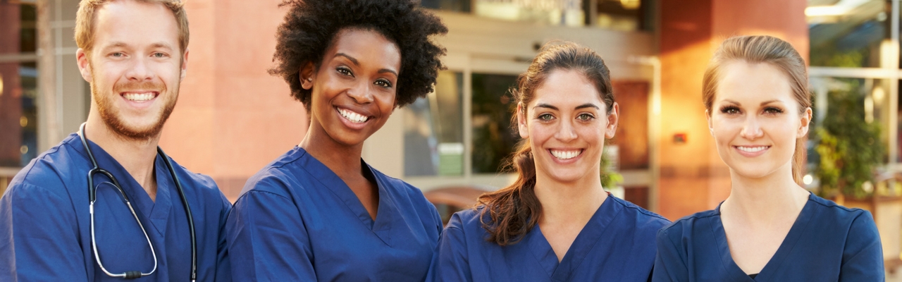 Group of people in scrubs smiling