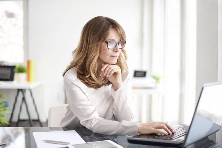 Woman at computer smiling