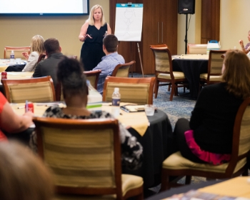 corporate training tile 2 teacher teaching a classroom full of people