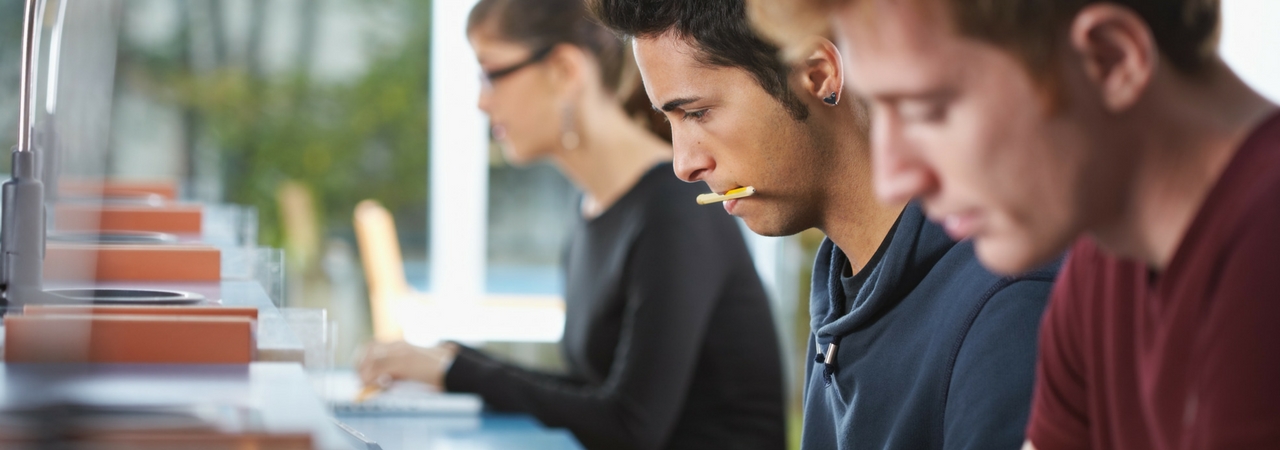 mcat face to face banner three people studying their own things and sitting at a long table