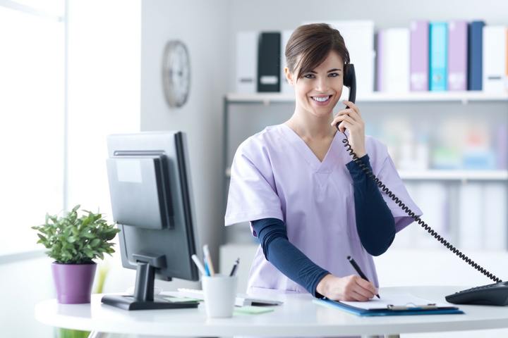 Nurse at Desk Women in scrubs on the phone at desk