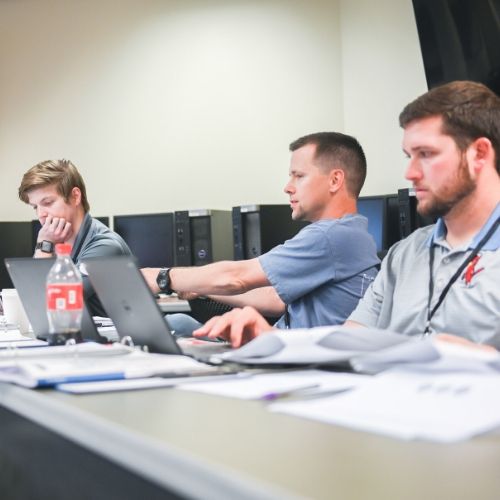online-education-tile.jpg Students discussing at a table