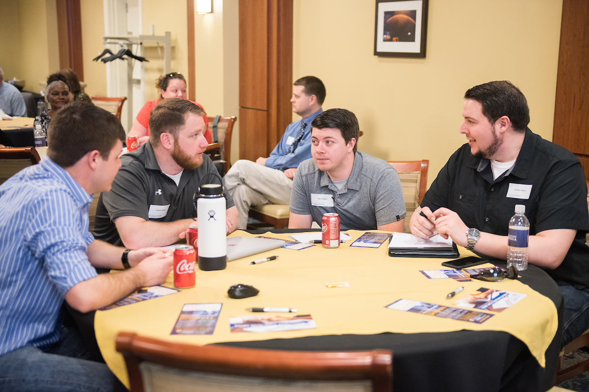 students-conversing.jpg Students conversing around a table