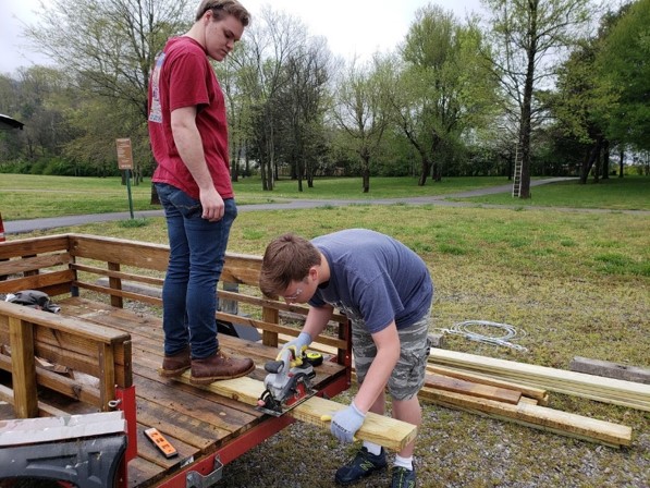 Male students sawing wood