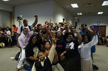 Multicultural Mentors and Mentees Program group of people posing for a picture with the black power fist