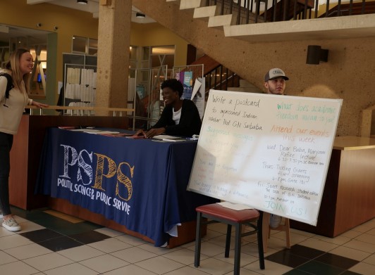 PSPS 4000 students Austin Hooper, Brianna Jones, and Hayley Pirrera tabling in the UC