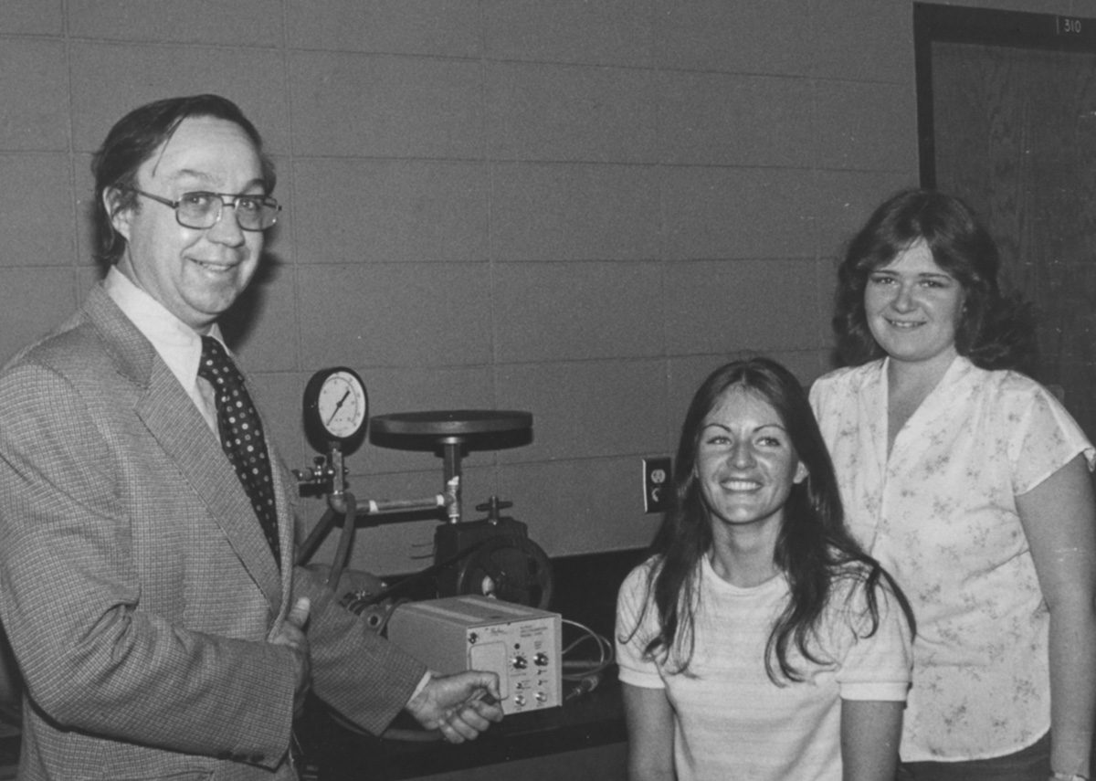 Grayson Walker with two female students