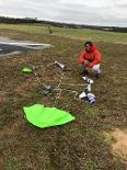 Member of UTC Rocket club with project on the grass