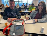 Two students working at a table