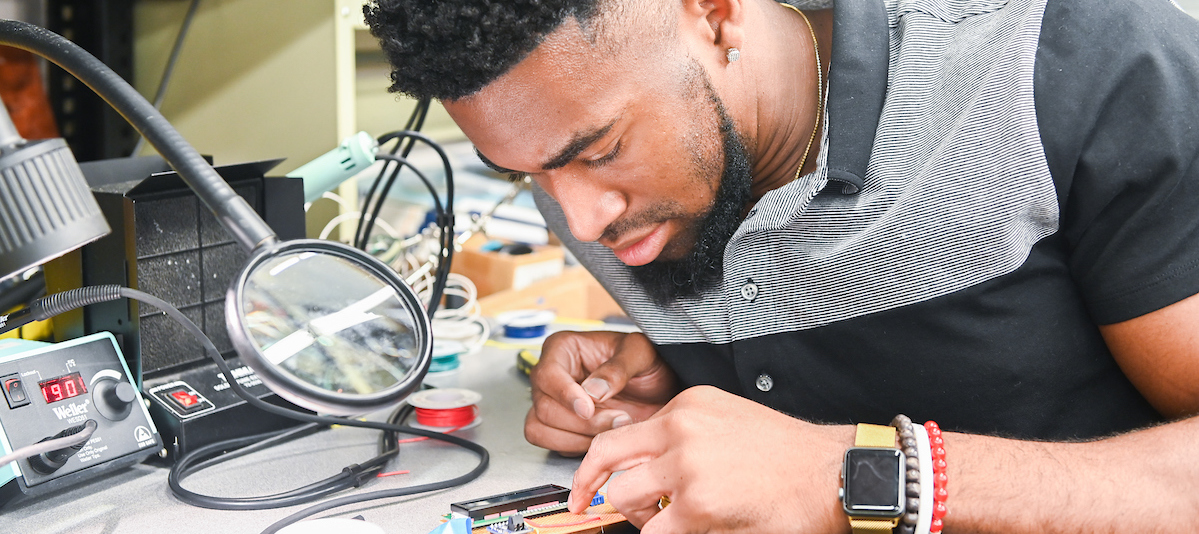 male student working on engineering project