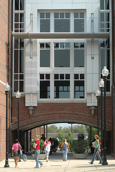 EMCS Building archway with students walking through it