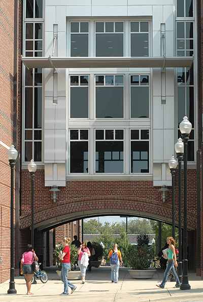 EMCS Building Faculty Page EMCS Building archway with students walking through it