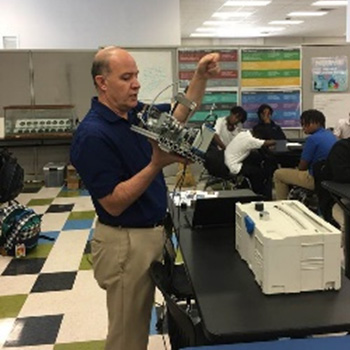 Teacher in classroom with technology