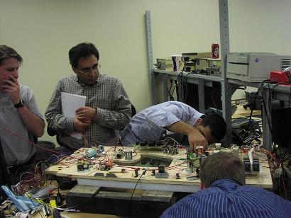 People working on electrical circuits