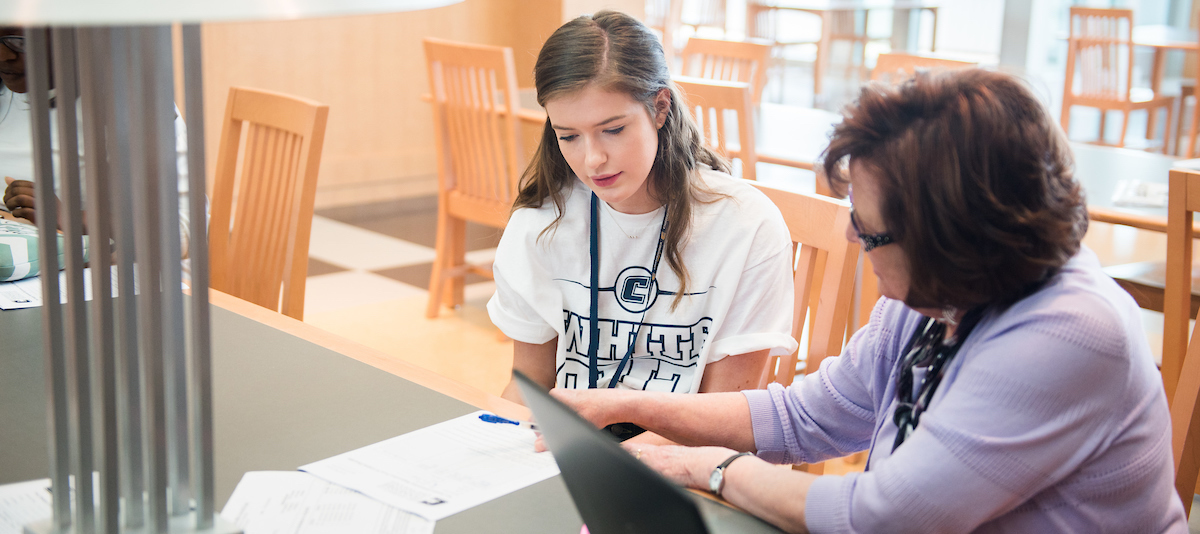 Student getting help on homework in UTC Library