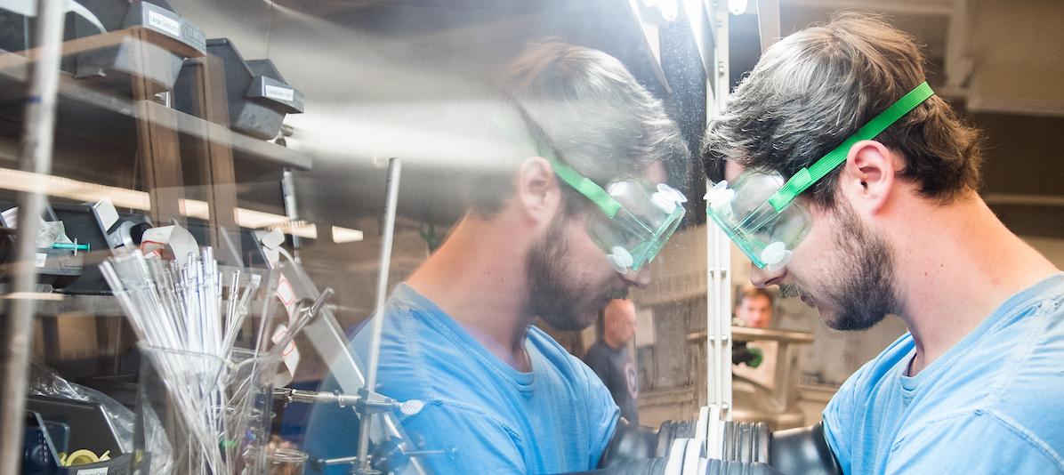 Student with goggles in chem lab