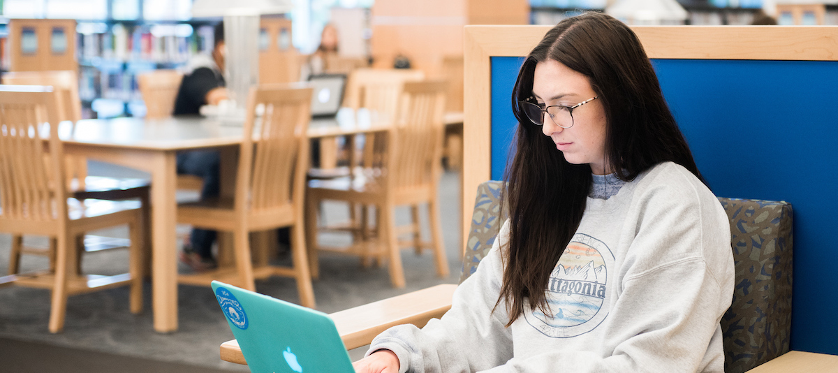 Studying Header Criminal Justice Female student studying in library