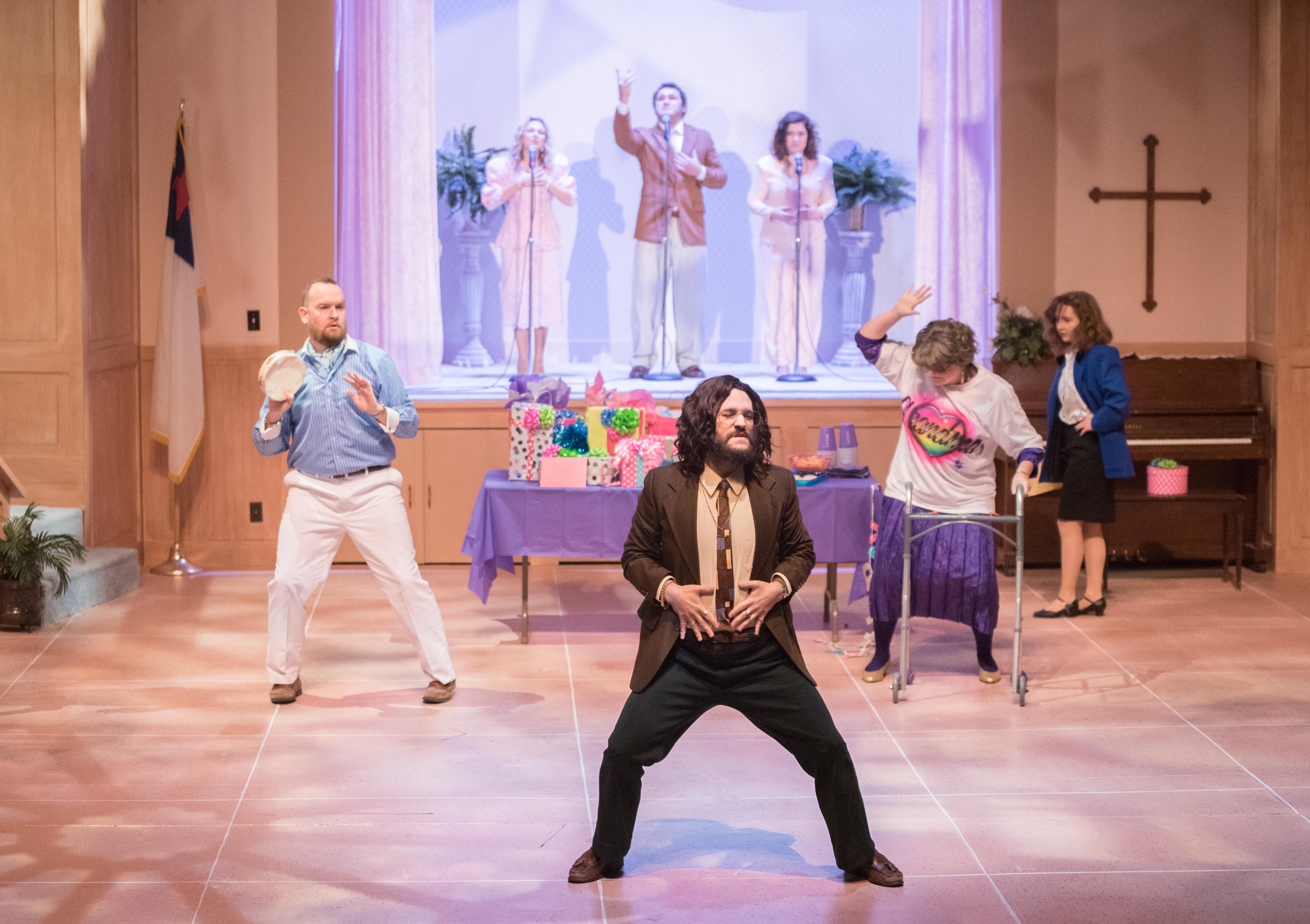cast members dance on stage