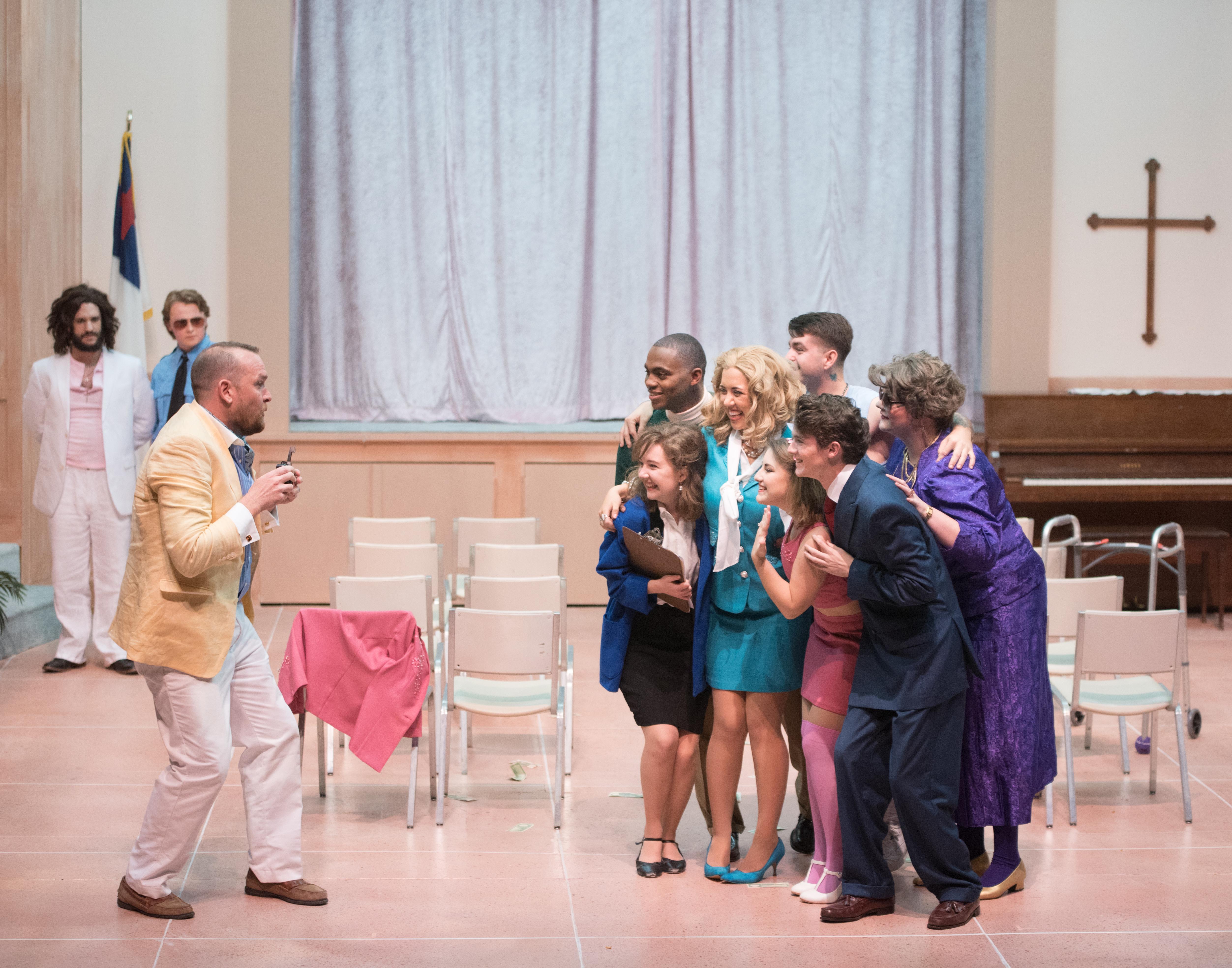 cast members on stage made to look like a church basement