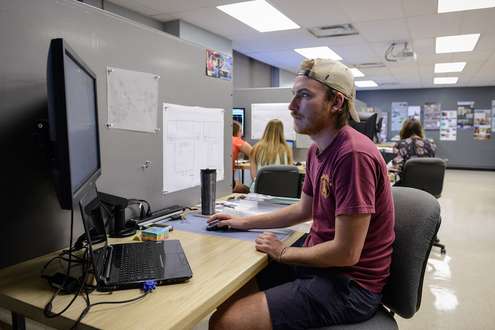 Interior Design Required Courses Male student on computer