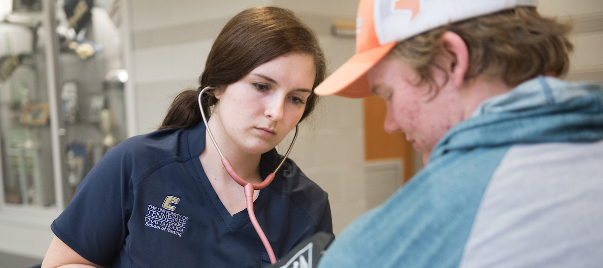 Female nursing student with male patient