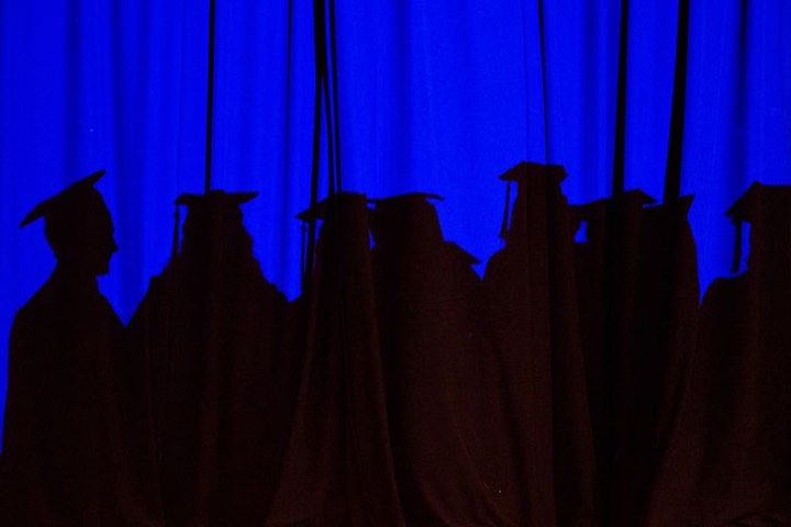 Resource Links Interior Architecture Shadow of students graduating on blue curtain