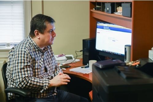 Tony Parsley sitting at his desk on a video call