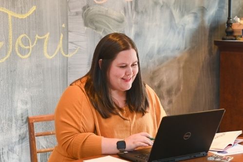 Laura Cagle working at home with her laptop on her desk