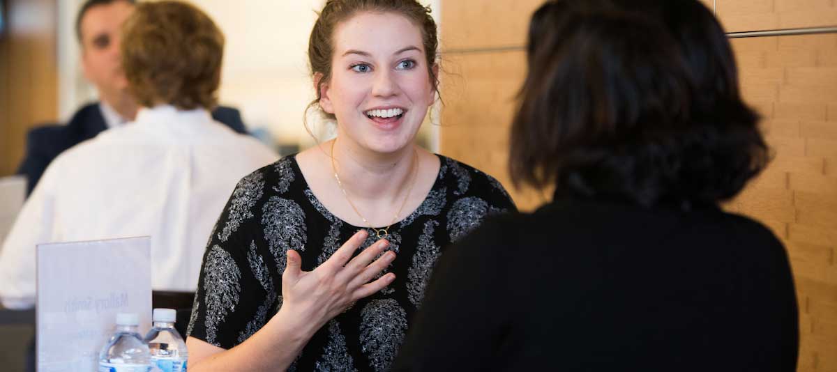 Women having a conversation at a conference