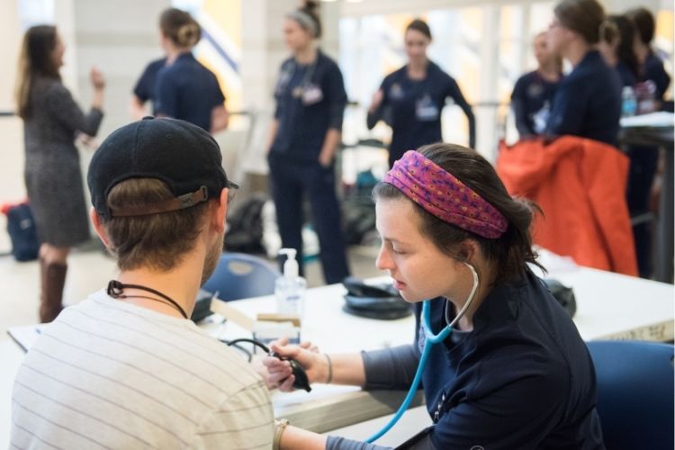 Nursing students checking blood pressure