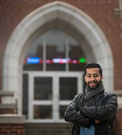 Man in front of Fletcher Hall