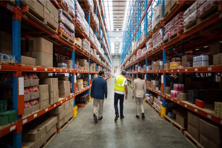 A group of individuals doing a tour of a warehouse