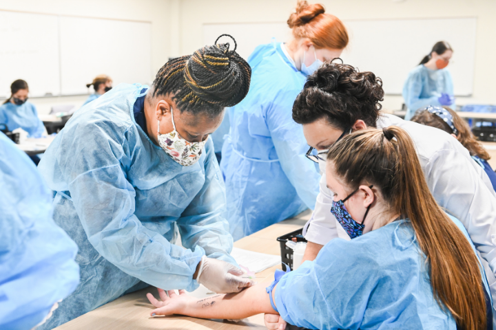 Phlebotomy technician students practicing their phlebotomy skills