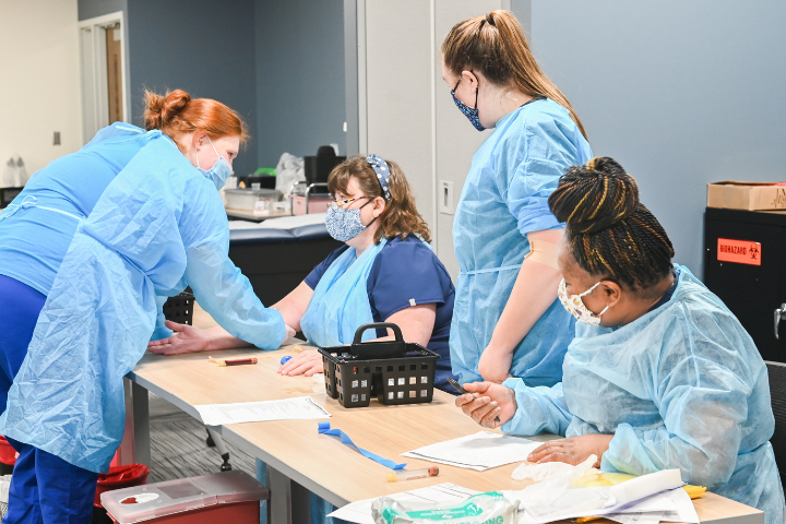 Phlebotomy technician students practicing their phlebotomy skills