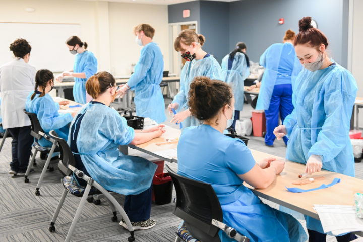 Phlebotomy technician students participating in a lab exercise