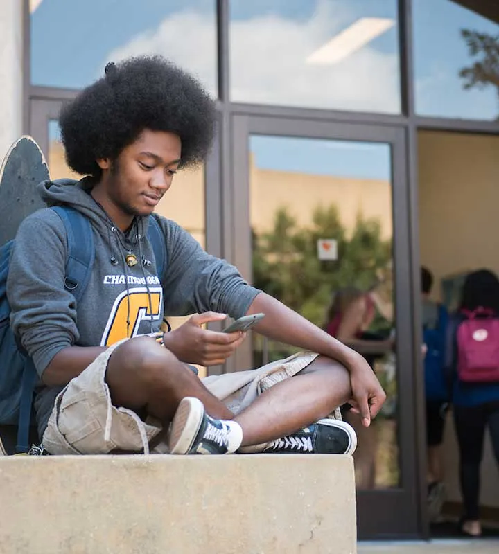 student sitting outside the university center
