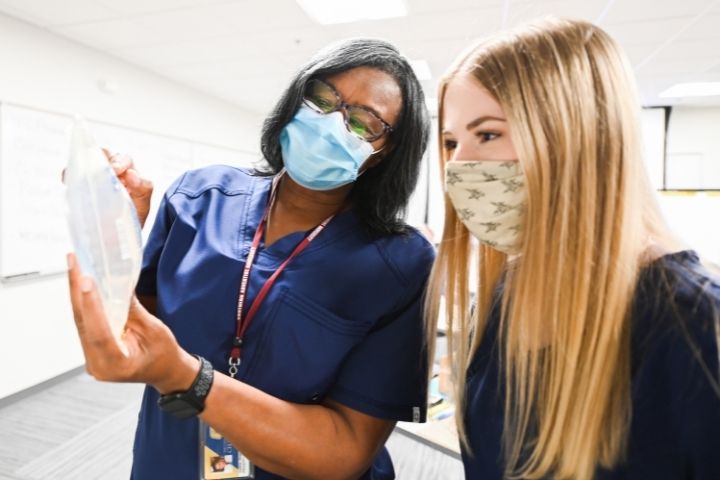 Pharmacy technician students learning how to fill IV bags