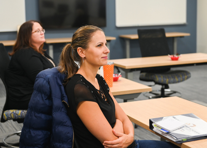 female adult student looking at board