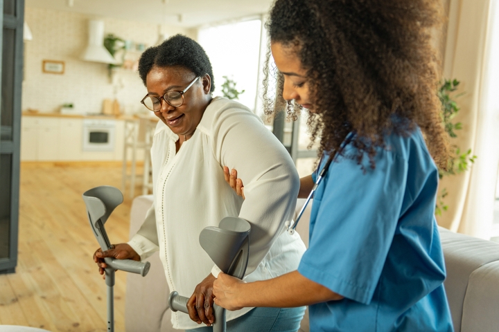 Female CNA Helping Patient Walk