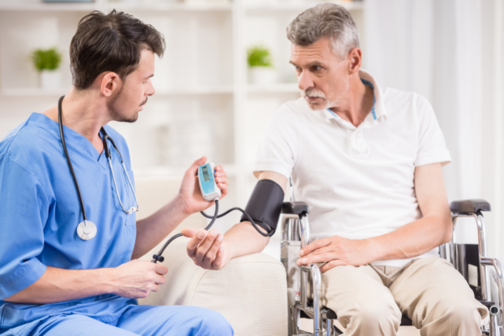 Male Nurse Taking Blood Pressure