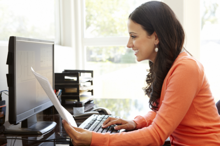 Student sits at computer to earn healthcare certification online.