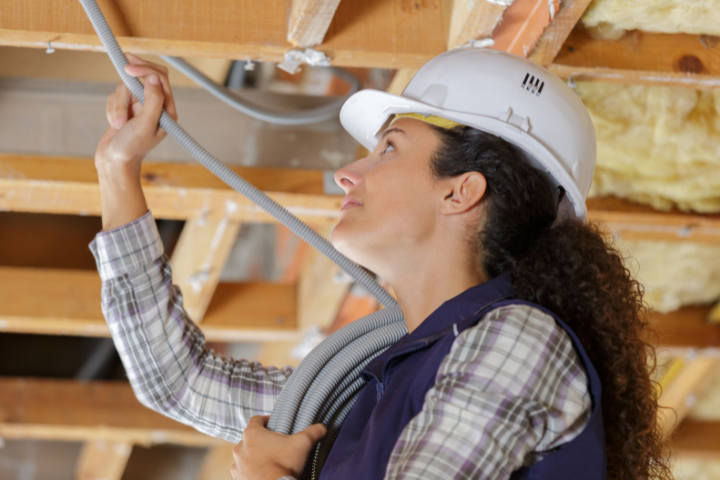 female electrician working with wires