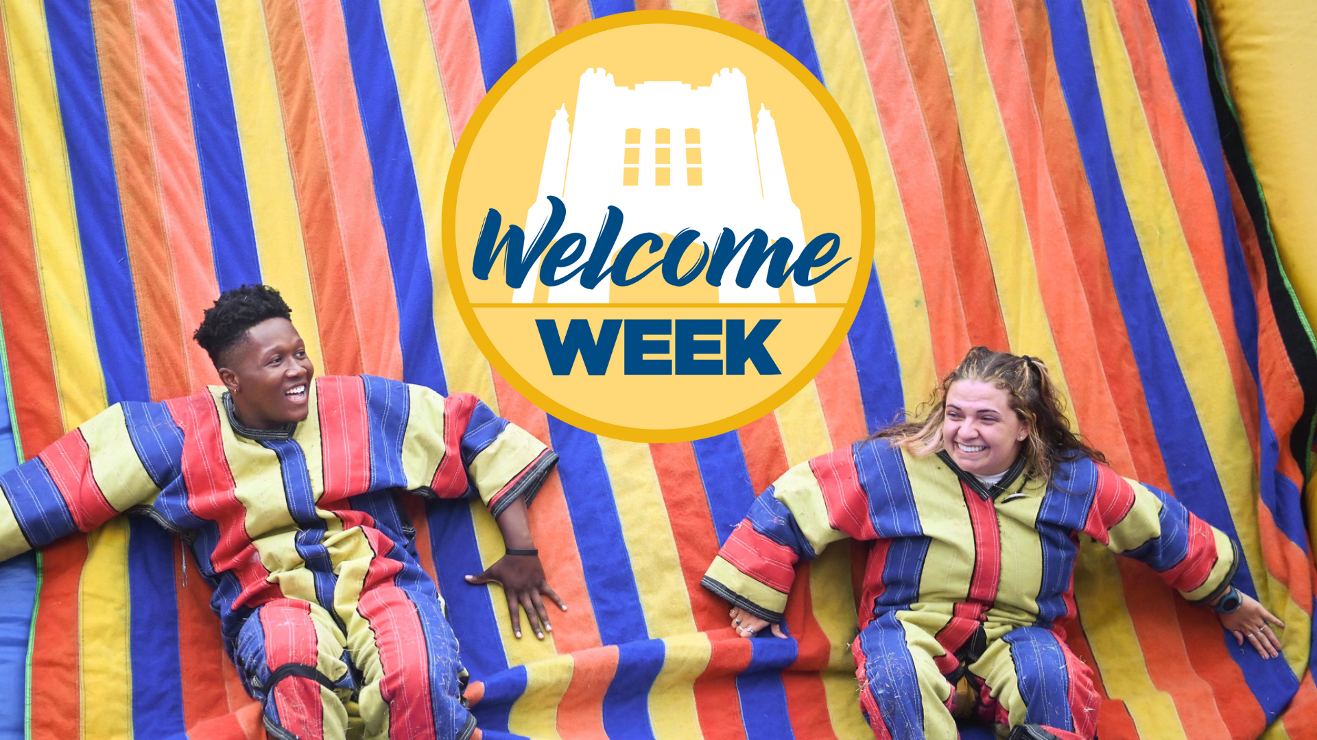 Two student on an inflatable with Welcome Week logo.