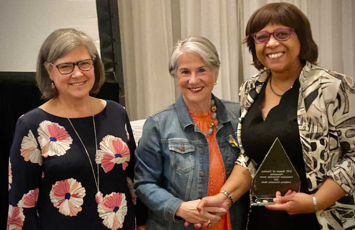 Chris Smith presents community service award to Michelle Pickett and Jill Fikkert 